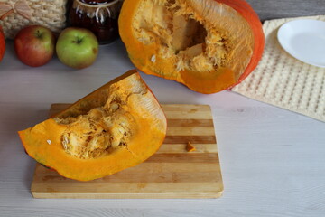 A cut pumpkin on the kitchen table, not yet peeled, will soon yield healthy juice.