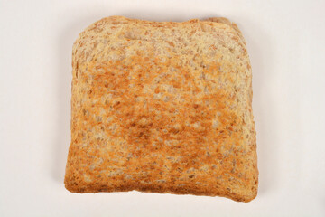 A top-down shot of a single slice of plain, golden-brown toast on a simple white background with plenty of copy space