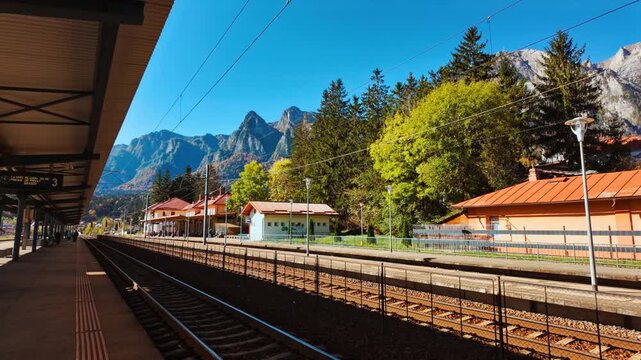 Busteni Train Station, Busteni, Transylvania, Romania, featuring traditional architecture, platform canopies and a landmark clock set against mountain slopes
