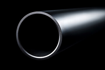 A close-up shot of a metal pipe against a dark background, showcasing its smooth surface and cylindrical shape.
