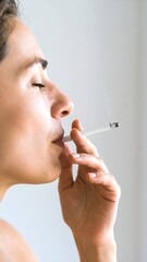 Obraz premium Woman smoking cigarette, profile view