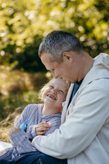 Adult father and little daughter are walking in the park
