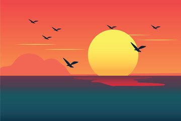 Sunset dipped below casting a warm glow with birds flying, over the peaceful sea