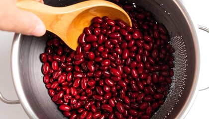 Red kidney beans being drained from a colander