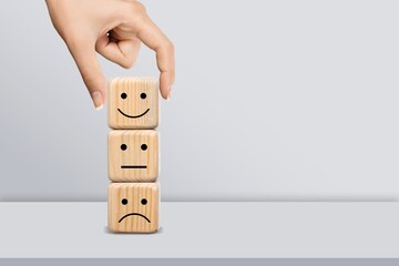 Hand choosing wooden block with face image