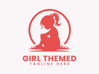 Silhouette of a girl with ponytail sitting inside a circle on grass.