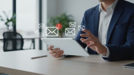 A businessman holding a tablet with floating glowing envelopes showing scam alert warning, fraud alert, and email spam notifications