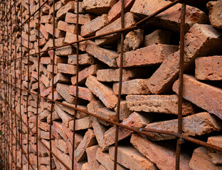 Stacked Red Clay Bricks in Construction Site - Traditional Building Materials Organized in Storage Rows for Architecture Project.