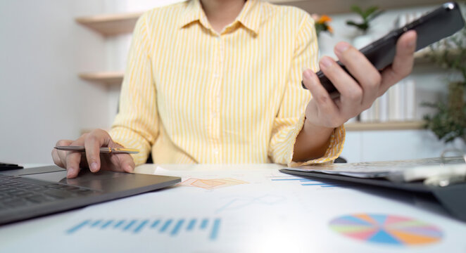 Business Analysis. Professional multitasking with phone and laptop in office.