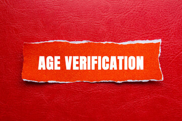 Age Verification message written on ripped torn orange paper piece on red background. Conceptual...