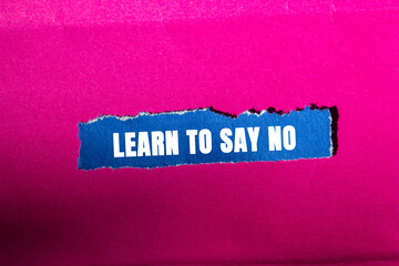 Learn to Say No message written on ripped torn blue paper piece on pink background. Conceptual Learn to Say No symbol. Copy space.