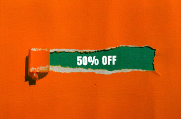 50 Off message written on ripped torn paper background. Conceptual 50 Off symbol. Copy space.