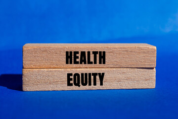 Health Equity message written on wooden blocks on blue background. Conceptual Health Equity symbol....