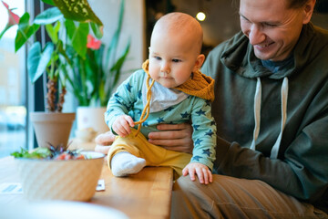 Father with child in cafe. Strong bond of parent and toddler, family values, love, happiness and modern lifestyle. Daily parenting moments of care and affection.