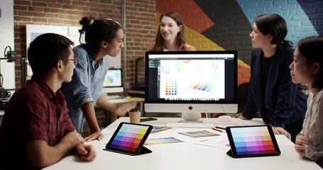 Creative team collaborating on design project in studio