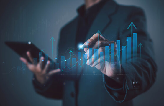 Businessman analyzing digital bar chart with rising arrows, symbolizing growth, financial success, data analytics, investment, progress, strategy, innovation, and corporate development.