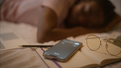 Sleeping napping African American woman female girl writer student lying down on bed sleep nap...