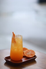 orange juice and some oranges on the side