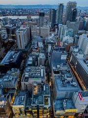Fototapeta premium Osaka, Japan – January 12, 2025: Aerial view of modern city skyline with tall buildings