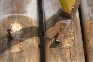 Pulling nails out of bamboo with a hammer. Old rusty nails. For graphic design, 3D rendering and banners