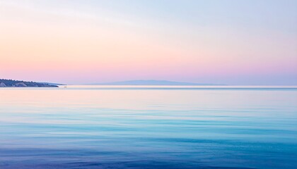 Calm pastel sunrise over tranquil water
