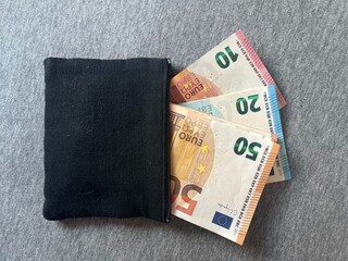 european banknotes in a black wallet pretruding 