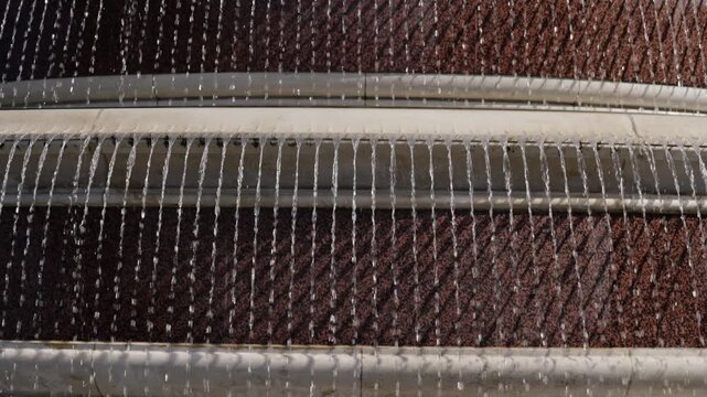 Close-up view of a fountain with streams of water falling in parallel lines