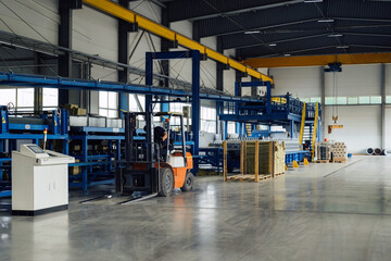 Industrial equipment for working with coil metal. Decoiler holds and unwinds metal coil. Slitting or cut-to-length line - cut coil metal into strips. Crane with hook is used for moving coils