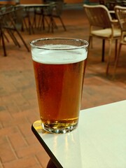 A pint of blonde beer on a table