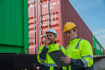 Efficient workers in safety gear inspect cargo containers on railway track, ensuring proper handling and safety protocols are followed. Their teamwork highlights importance of safety in logistics