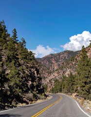 Mountain road winding through a canyon under a clear sky