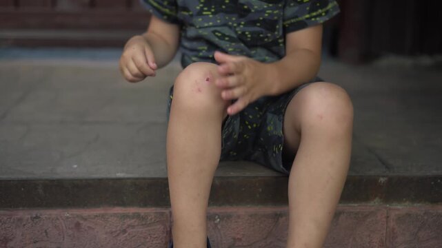 a child sits on the porch on a hot summer day