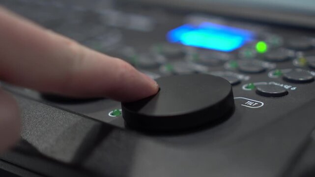close-up of finger adjusting tilt shuttle on light