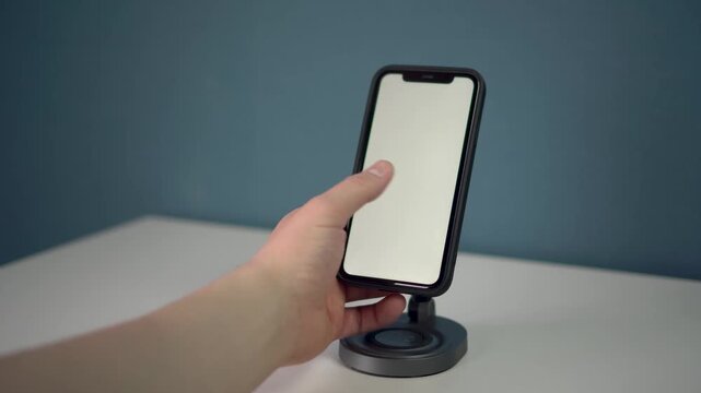 the smartphone is on a wireless charging pad