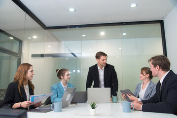 Efficient business meeting with professionals discussing strategies and analyzing data. atmosphere is collaborative and focused, showcasing teamwork and modern office design.