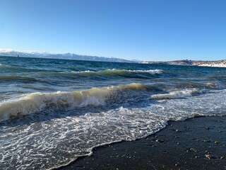 Stunning photo of the Pacific Ocean with volcanoes, clear sky, and mild waves. Ideal for travel,...
