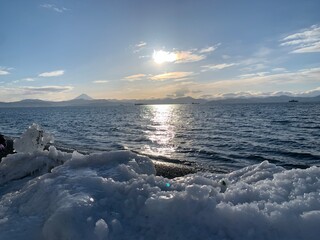 Stunning photo of the Pacific Ocean with volcanoes, clear sky, and mild waves. Ideal for travel, design, and editorial use.