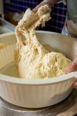 Baker Hands Kneading Dough in a Bowl The Concept of Artisan Baking