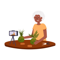 Grandma shoots a blog about caring for and growing houseplants. Blog of an elderly blogger. Houseplant kokedama