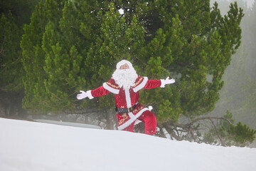 Santa Claus throwing snow in winter forest