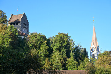 Morning view of Uster, with the iconic Uster Castle tower and the church steeple rising above the trees