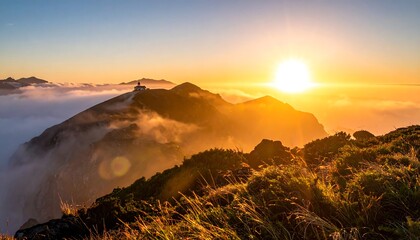 Mountaintop sunset over clouds