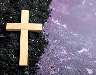 Wooden cross on ashes and purple background