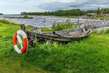 Old wooden fishing boat with a livesfaver in Finland