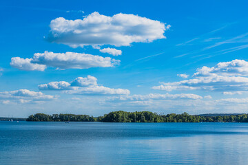 Scenic view of Lake Scharmützelsee with decorative clouds in blue sky