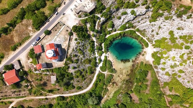 Top down view of Cetina River spring Eye of the Earth beside Church of Holy Salvation in Croatia