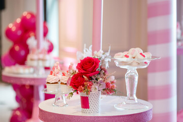 Roses on a pink background with cakes