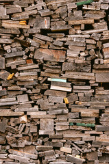 Wooden planks stacked and processed for fireplace. Raw wood in various shades.