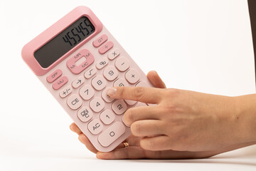 Person holding a pink calculator