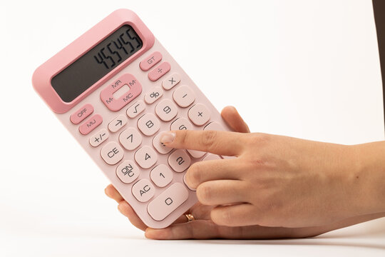 Person holding a pink calculator